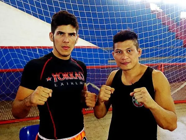 Kevem ao lado do lutador tailandês Jubjub Deaw Patsanon, de guarda, no ginásio
